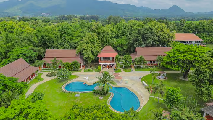 Aerial view of the Chiang Dao resort with villas, pools, and mountains