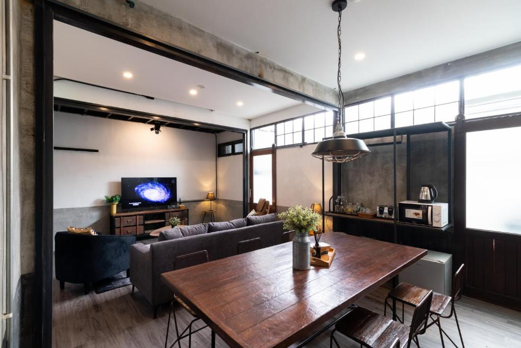 Industrial-style dining and living area with large wooden table