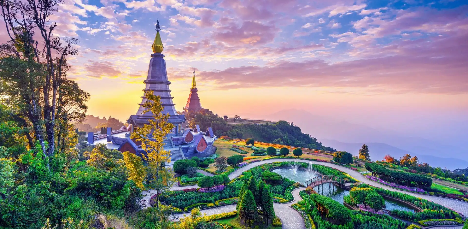 Twin royal pagodas surrounded by landscaped gardens at Doi Inthanon in northern Thailand at sunset