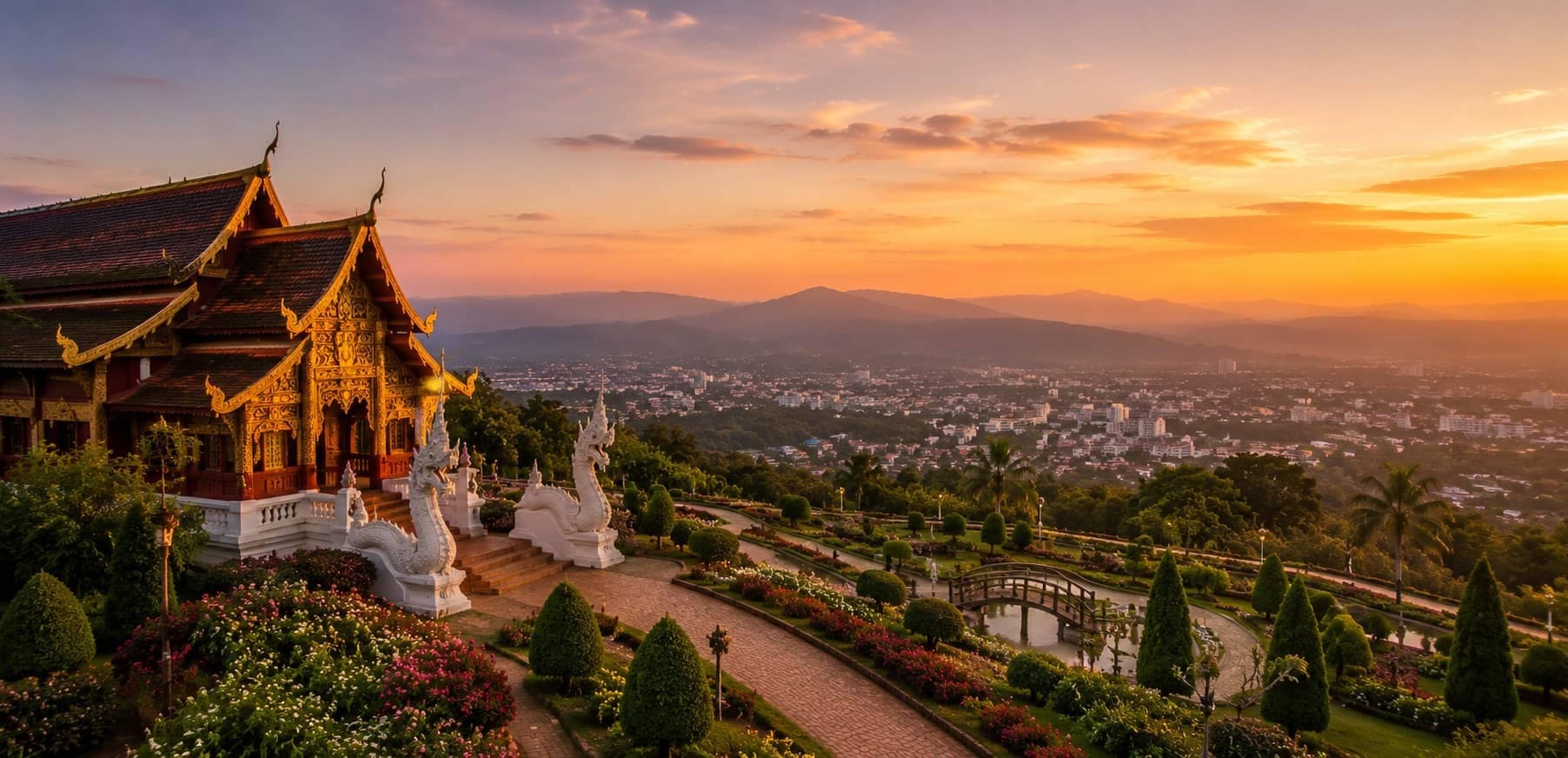 Golden Thai temple overlooking Chiang Mai city and mountains at sunset