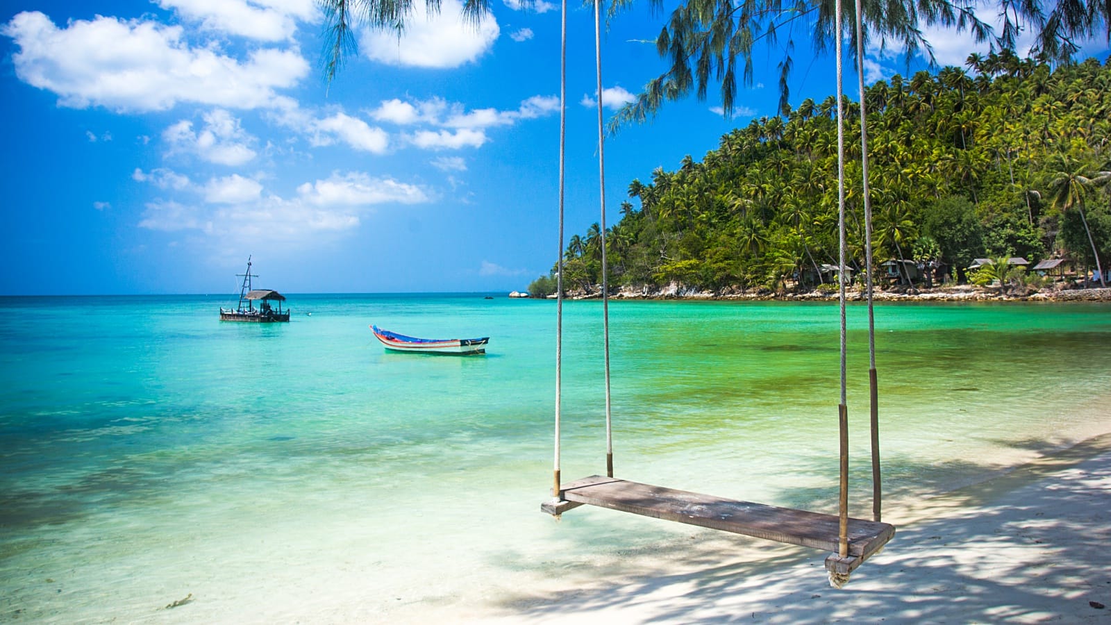 Tropical beach in Koh Phangan with turquoise water and palm trees