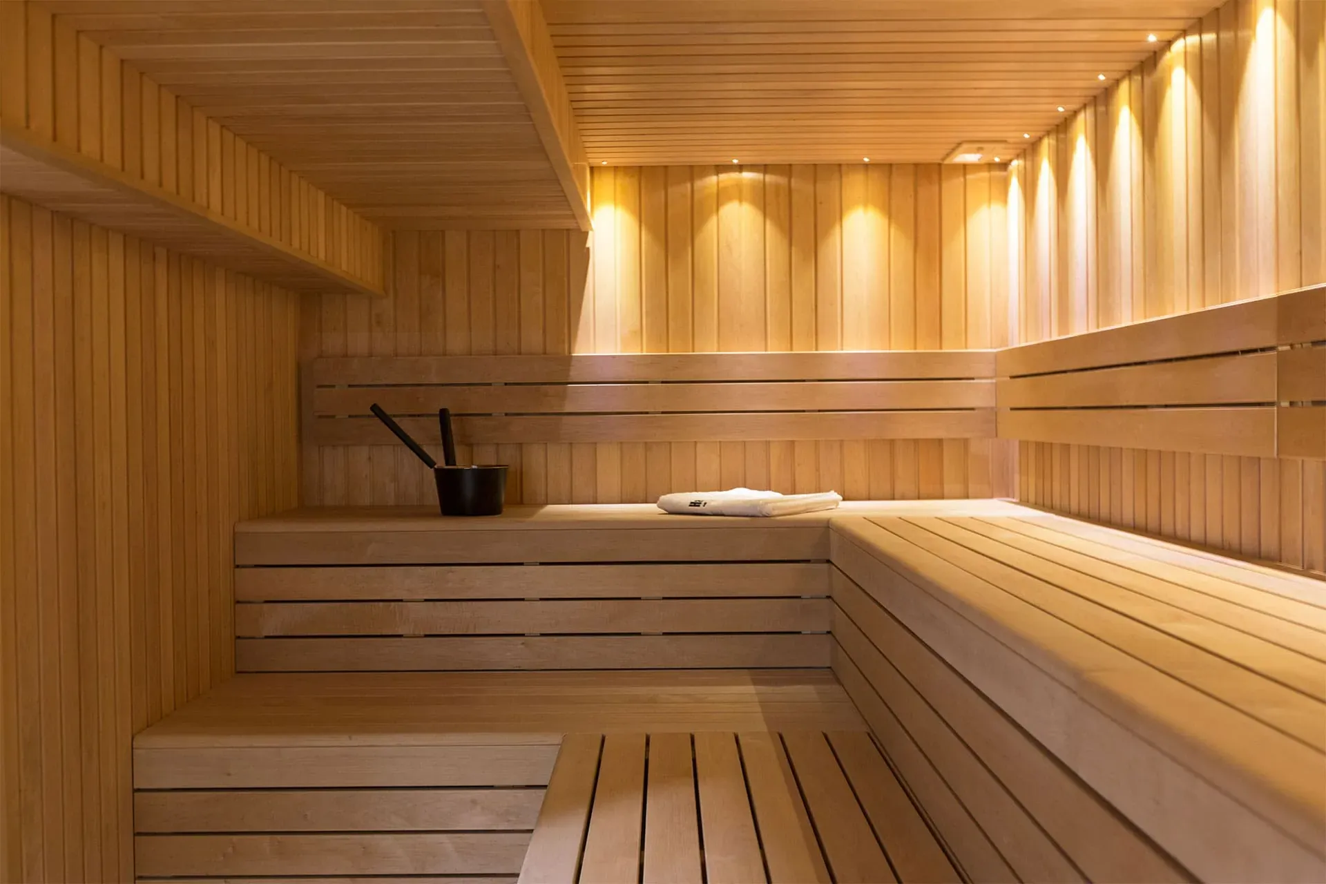 Warm wood-paneled Finnish-style sauna interior at The Ark