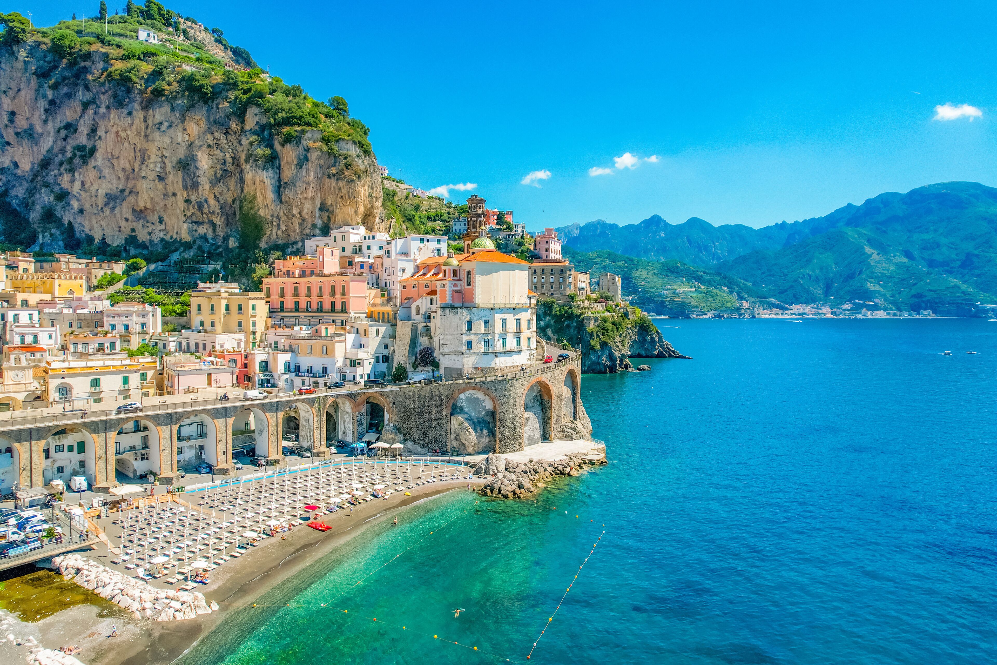 Pastel cliffside town on the Amalfi Coast above turquoise water